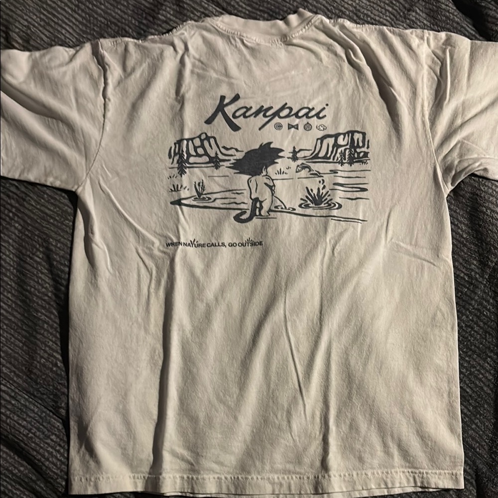 Kanpai Graphic T-Shirt in White
Kid Goku taking a leak